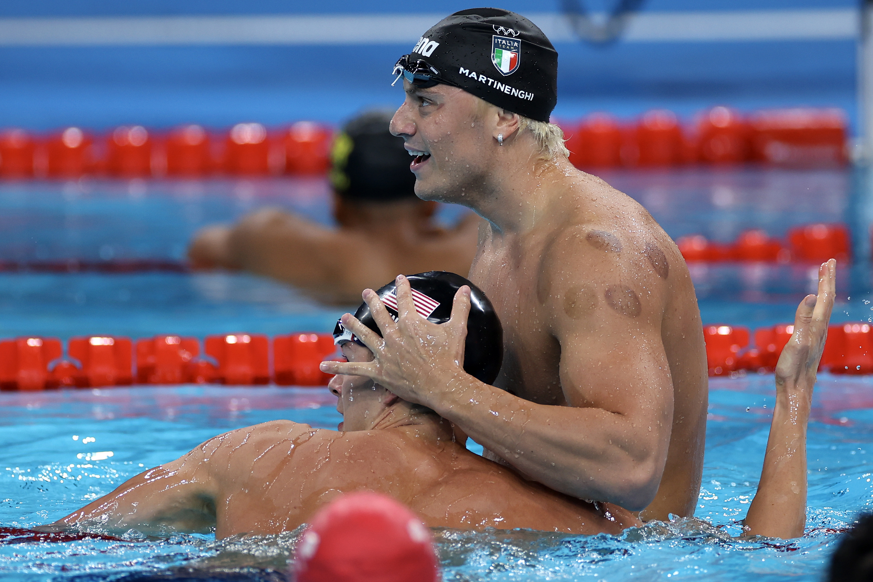 NANTERRE, FRANCE - JULY 28: Nic Fink of Team United States, who won silver, congratulates Nicolo Martinenghi of Team Italy after he wins gold in the Men?s 100m Breaststroke Final on day two of the Olympic Games Paris 2024 at Paris La Defense Arena on July 28, 2024 in Nanterre, France. (Photo by Sarah Stier/Getty Images)