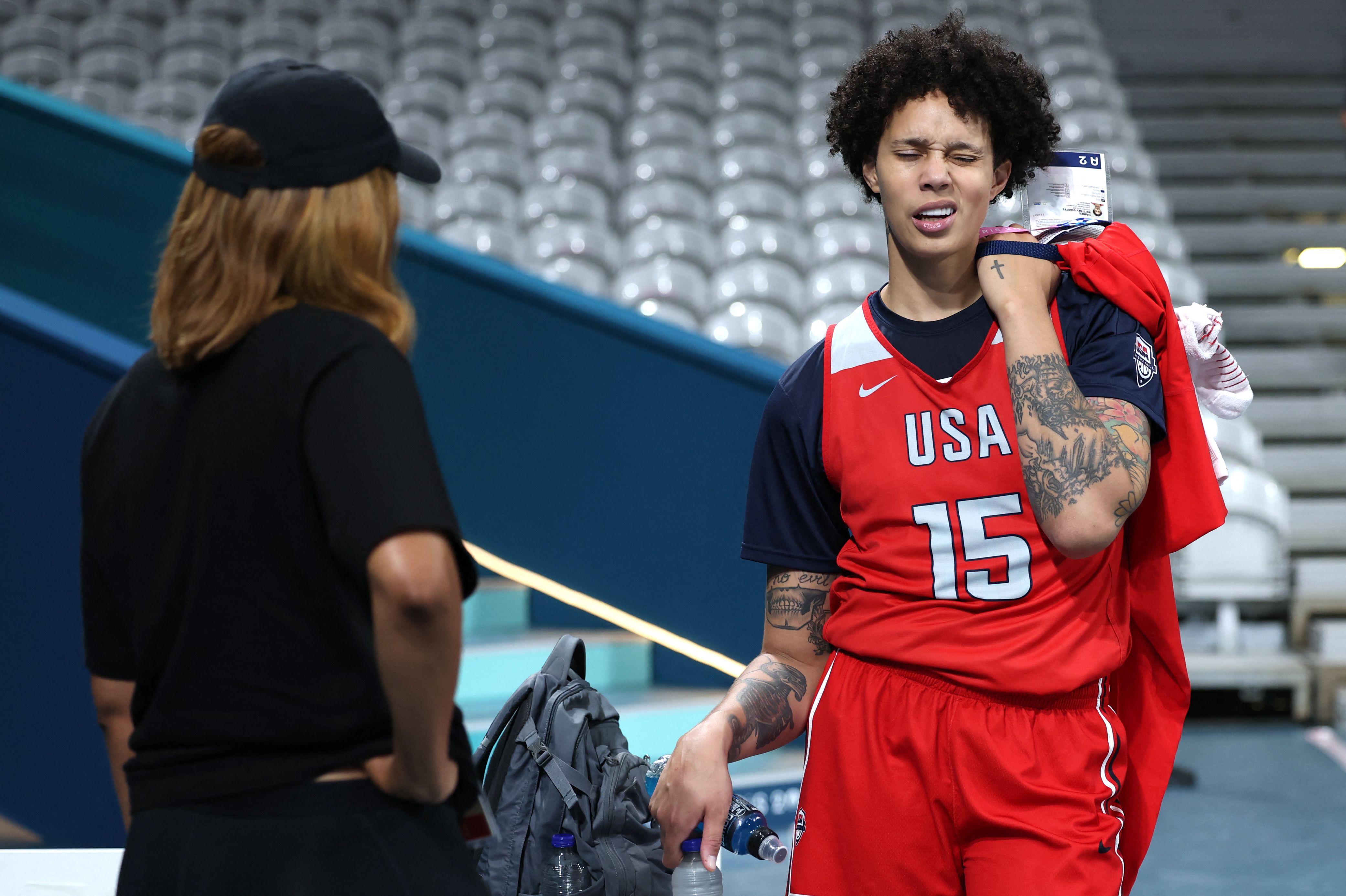 US #15 Brittney Griner (R) answers to a journalist after a training session at the Pierre-Mauroy stadium in Villeneuve-dAscq, northern France, on July 25, 2024, ahead of the Paris 2024 Olympic games. (Photo by Thomas COEX / AFP)