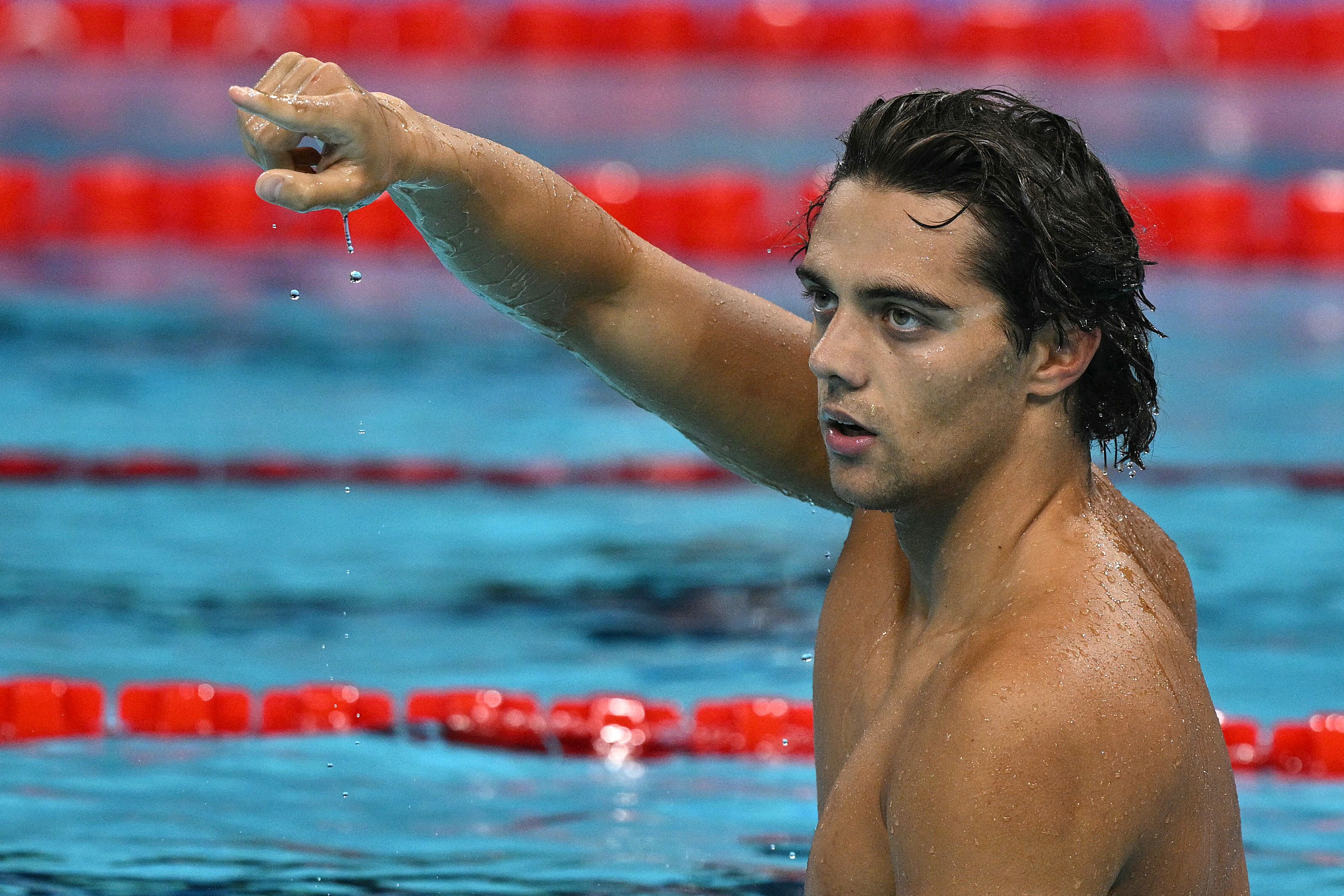 Italy's Thomas Ceccon celebrates after winning  the final of the men's 100m backstroke swimming event during the Paris 2024 Olympic Games at the Paris La Defense Arena in Nanterre, west of Paris, on July 29, 2024. (Photo by Oli SCARFF / AFP)