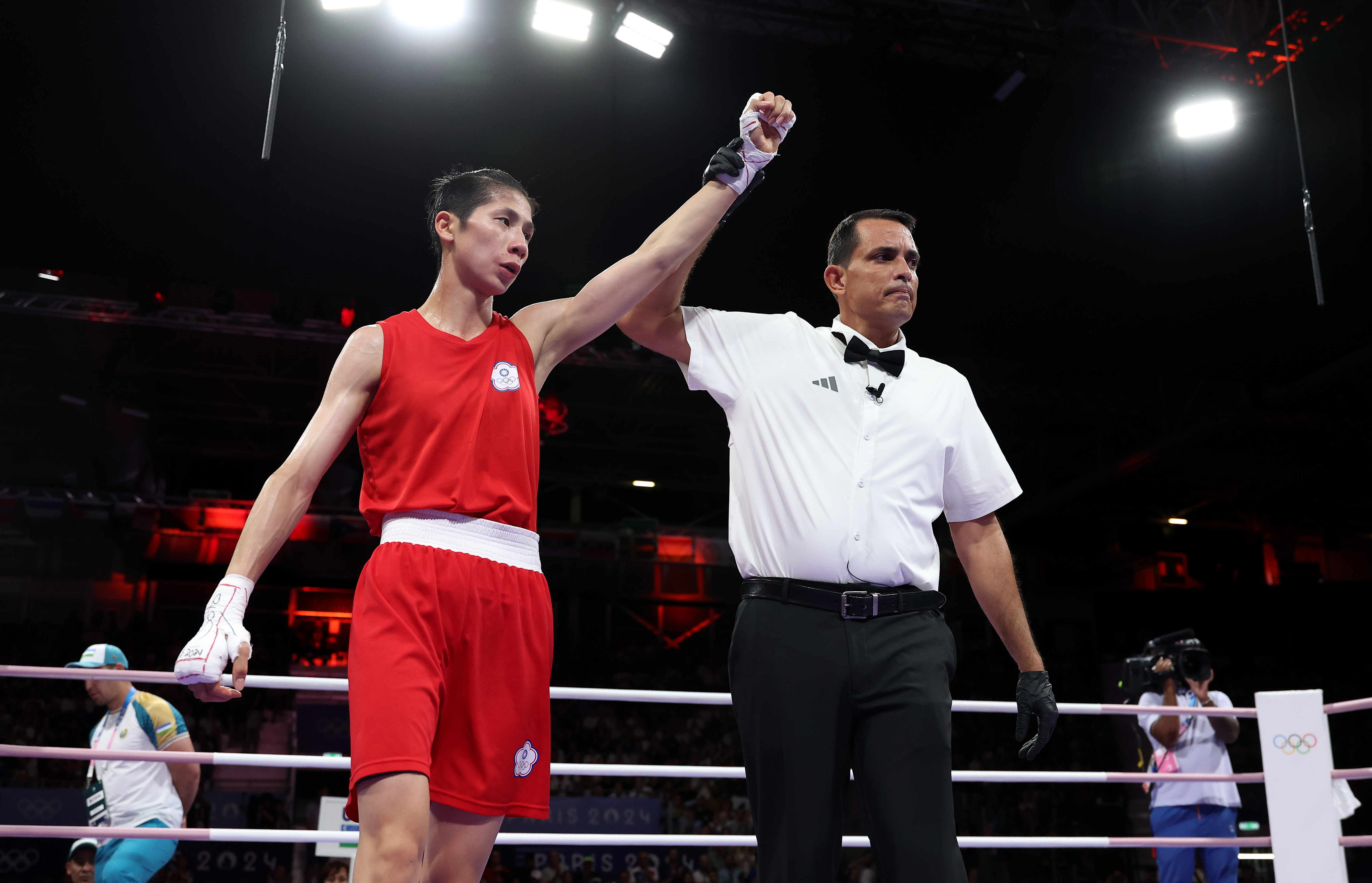PARIS, FRANCE - AUGUST 02: Match Referee Emanuel Ferreira raises the hand of Yu Ting Lin of Team Chinese Taipei to announce the winner of the Women's 57kg preliminary round match against Sitora Turdibekova of Team Uzbekistan on day seven of the Olympic Games Paris 2024 at North Paris Arena on August 02, 2024 in Paris, France. (Photo by Richard Pelham/Getty Images)