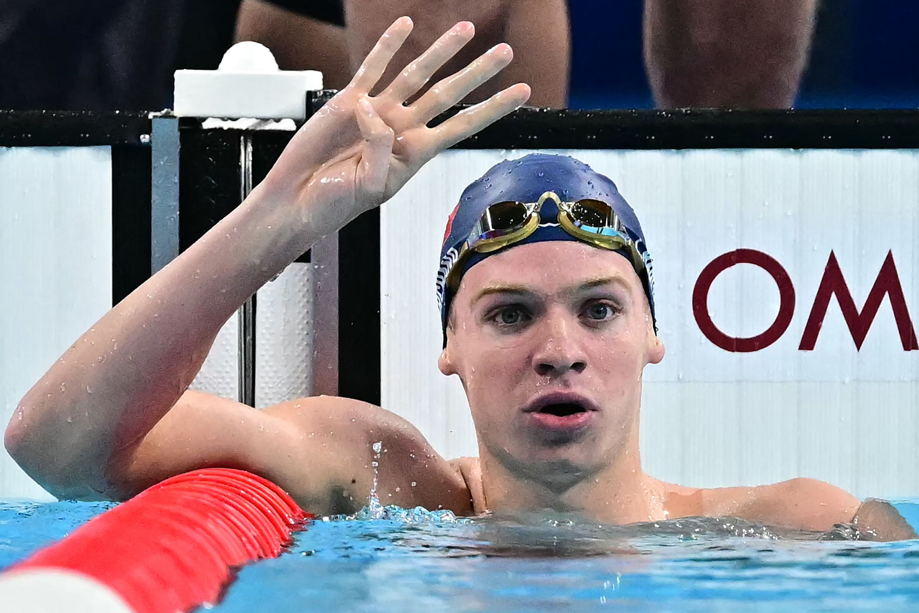 TOPSHOT - Gold medallist France's Leon Marchand gestures while celebrating after competing in the final of the men's 200m individual medley swimming event during the Paris 2024 Olympic Games at the Paris La Defense Arena in Nanterre, west of Paris, on August 2, 2024. (Photo by Manan VATSYAYANA / AFP)