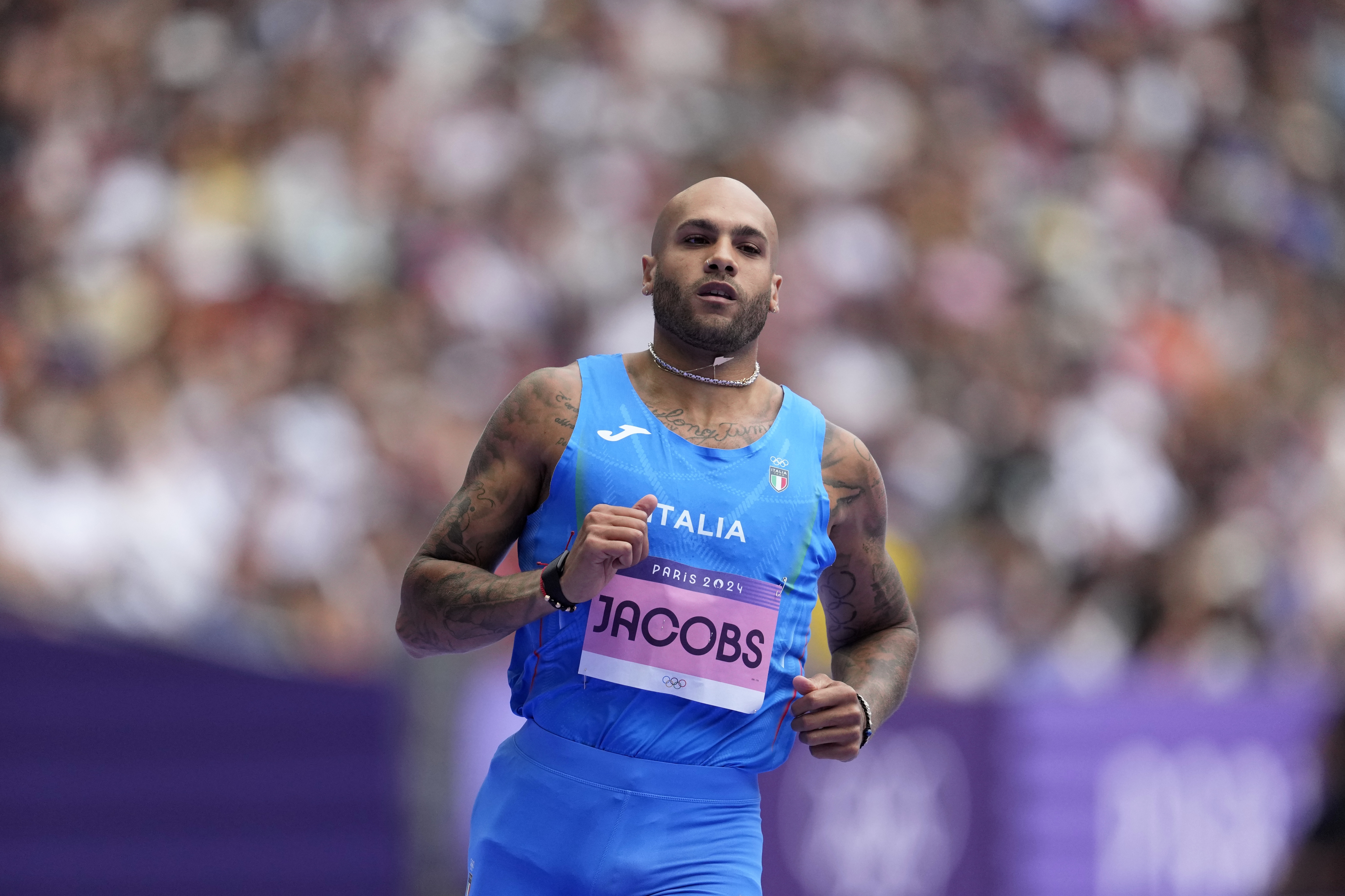 Lamont Marcell Jacobs, of Italy, reacts after qualifying in a men's 100 meters round 1 heat at the 2024 Summer Olympics, Saturday, Aug. 3, 2024, in Saint-Denis, France. (AP Photo/Ashley Landis)