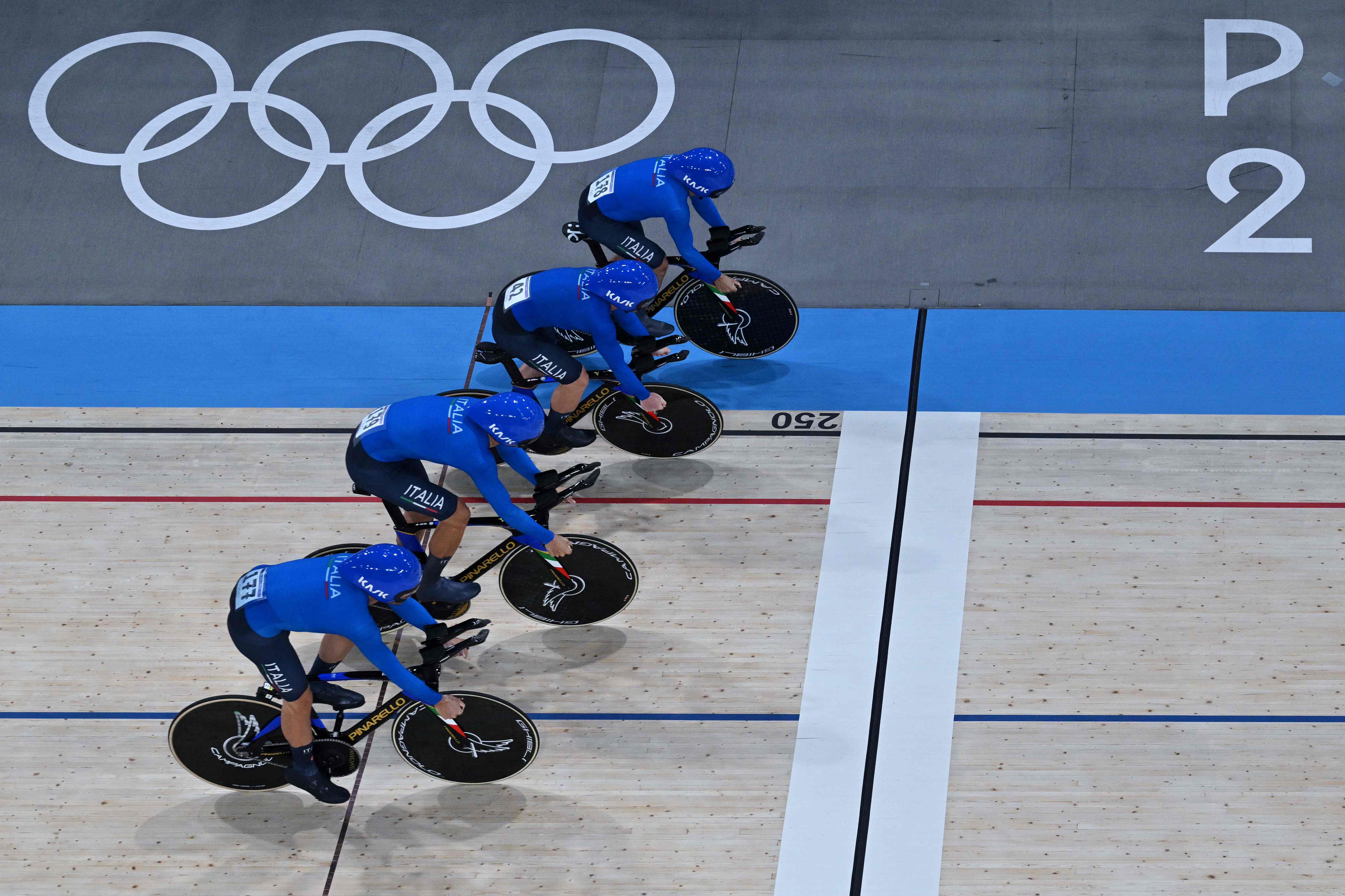 Team Italy Italy's Simone Consonni, Italy's Filippo Ganna, Italy's Francesco Lamon and Italy's Jonathan Milan compete in a men's track cycling team pursuit qualifying round of the Paris 2024 Olympic Games at the Saint-Quentin-en-Yvelines National Velodrome in Montigny-le-Bretonneux, south-west of Paris, on August 5, 2024. (Photo by Sebastien BOZON / AFP)