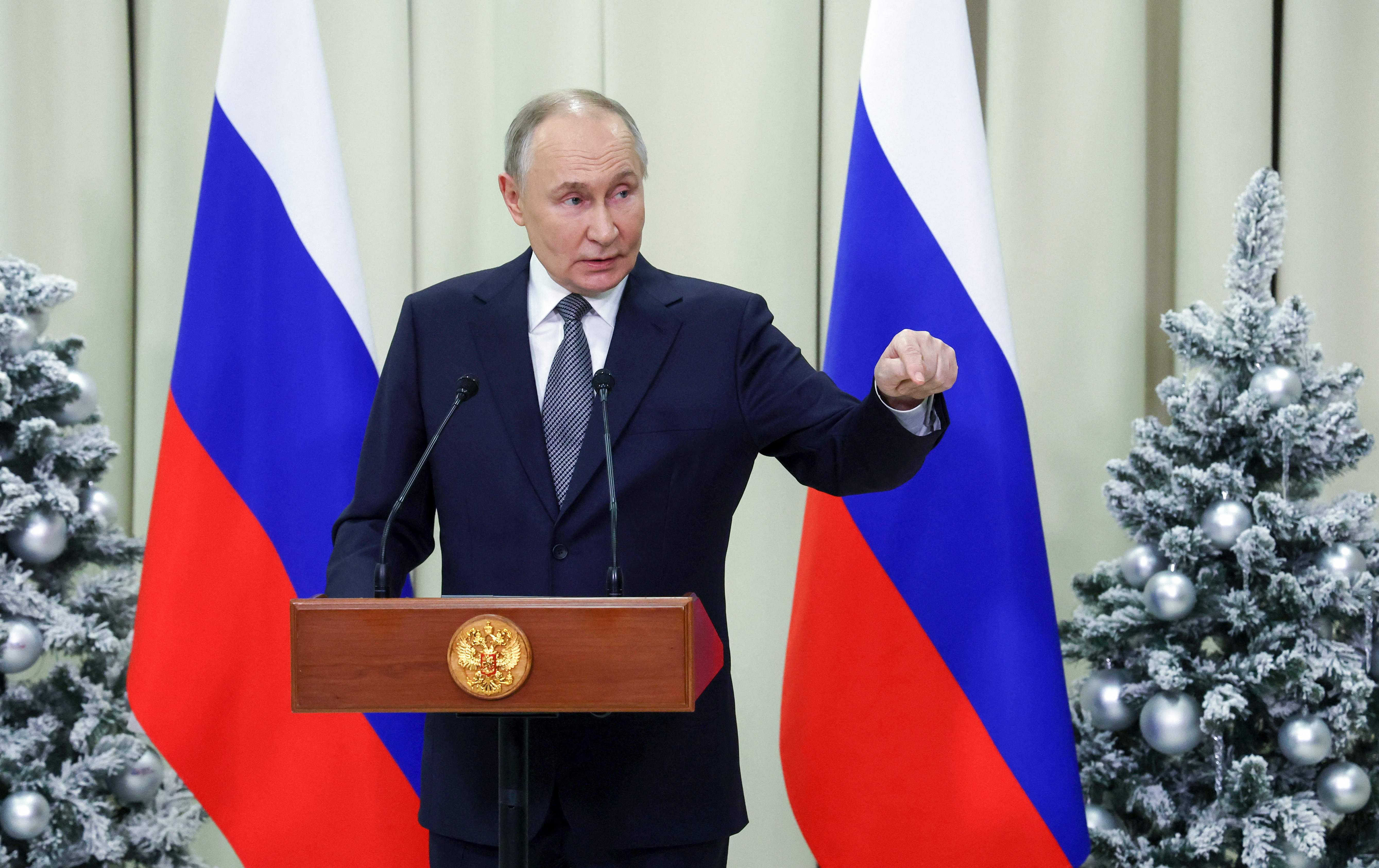 In this pool photograph distributed by the Russian state agency Sputnik, Russia's President Vladimir Putin meets with the media after a meeting of the Supreme Eurasian Economic Council at Igora ski resort in the Leningrad region on December 26, 2024. (Photo by Alexandr Demyanchuk / POOL / AFP)