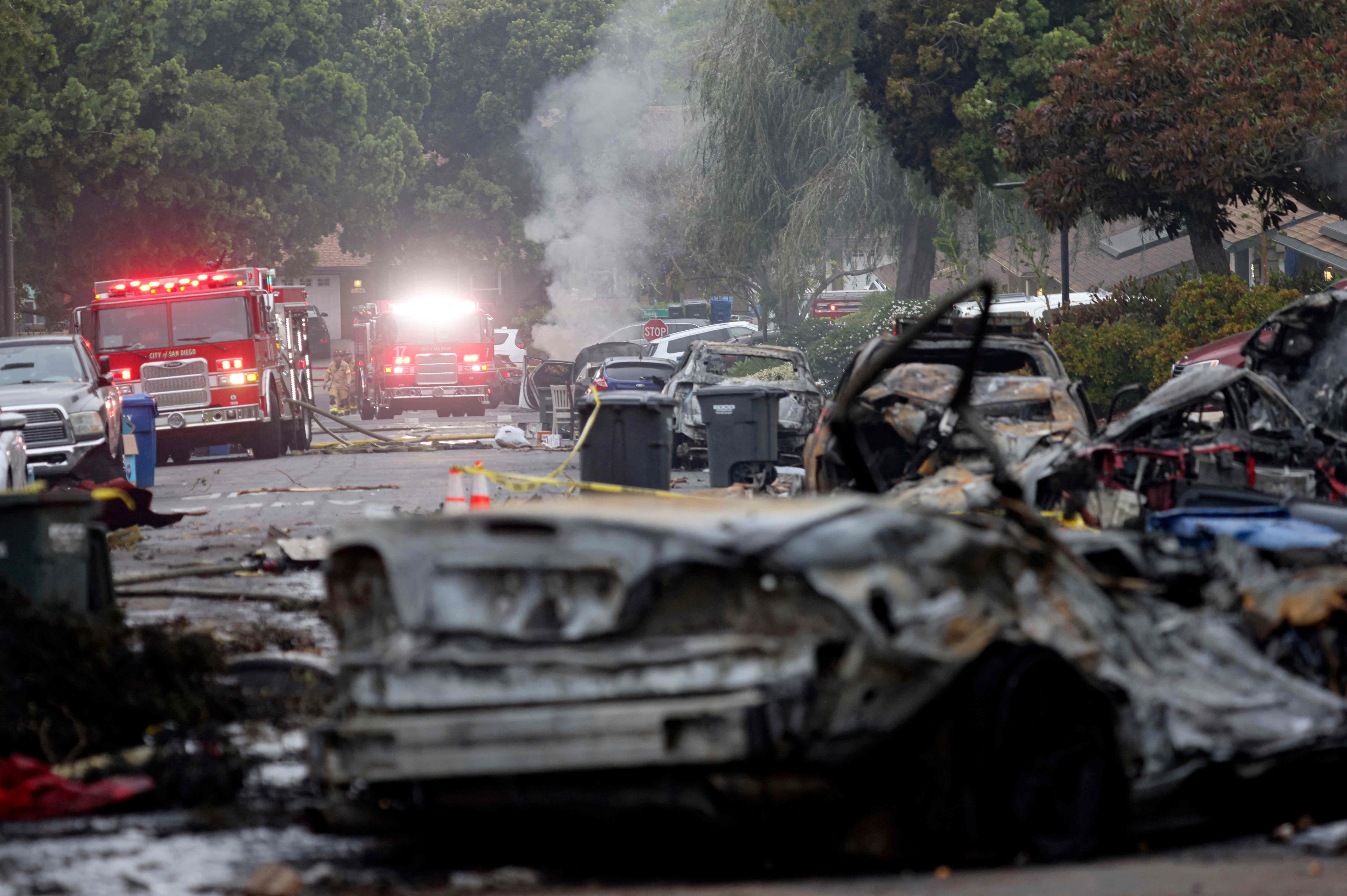 Firefighters Work the Site Where A Small Plane Crashed Into a San Diego, California, Residential Street on May 22, 2025. The Federal Aviation Authority Said in Cessna 550 Crashed at Around 3:45 AM Local Time. The Neighborhood is Close to the Montgomery-Gibbs Executive Airport. The Crash Left a 