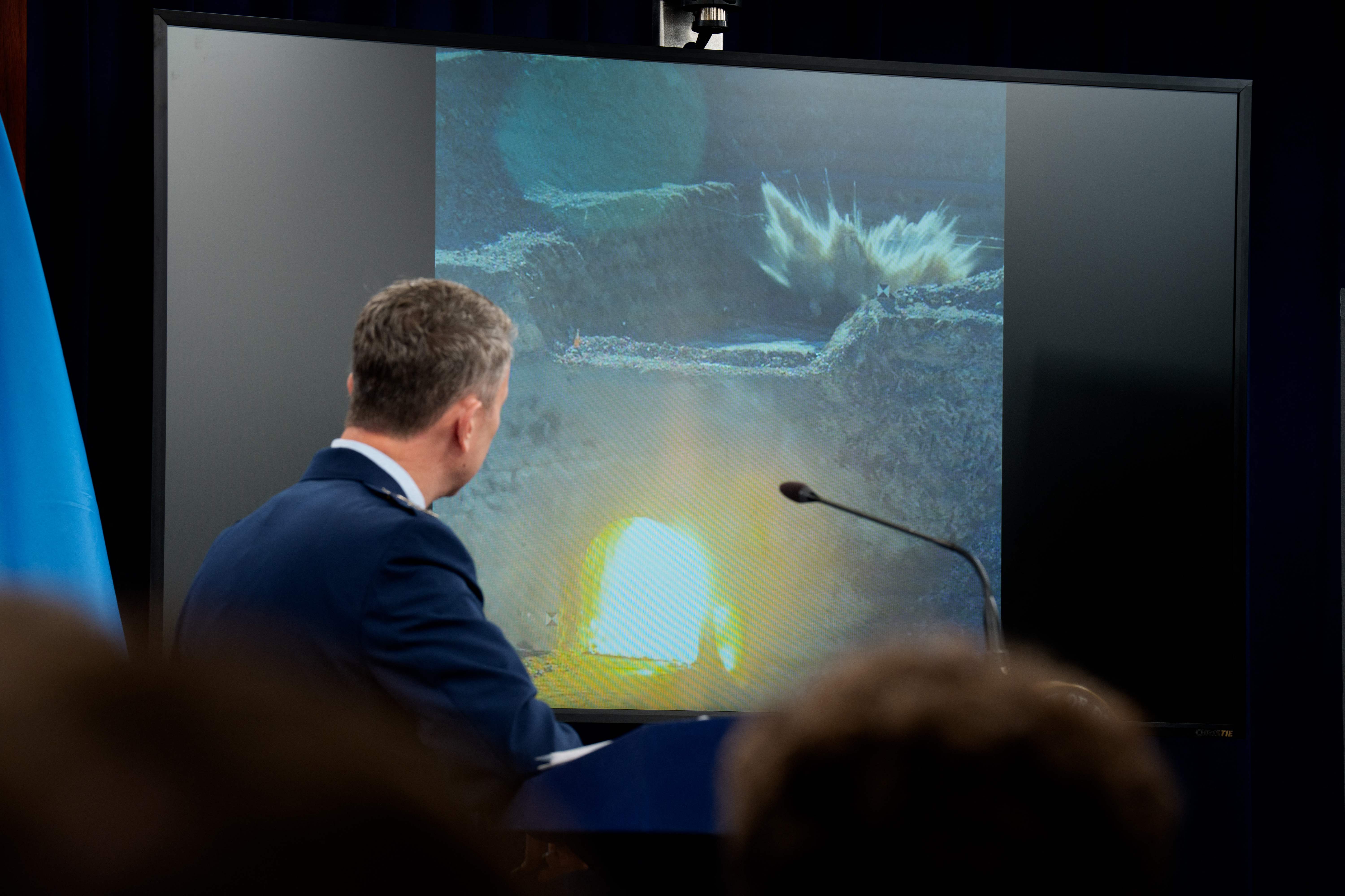 ARLINGTON, VIRGINIA - JUNE 26: Chairman of the Joint Chiefs of Staff Air Force Gen. Dan Caine turns to watch a video of a bombing test of the GBU-57A/B Massive Ordnance Penetrator (MOP) used in the attack on the Iranian Fordow Fuel Enrichment Plant during a news conference with U.S. Defense Secretary Pete Hegseth at the Pentagon on June 26, 2025 in Arlington, Virginia. The Department of Defense top officials gave an update after three Iranian nuclear facilities were struck by the U.S. military last weekend and Iran countered by launching missiles at Al Udeid Air Base in Doha, Qatar.   Andrew Harnik/Getty Images/AFP (Photo by Andrew Harnik / GETTY IMAGES NORTH AMERICA / Getty Images via AFP)