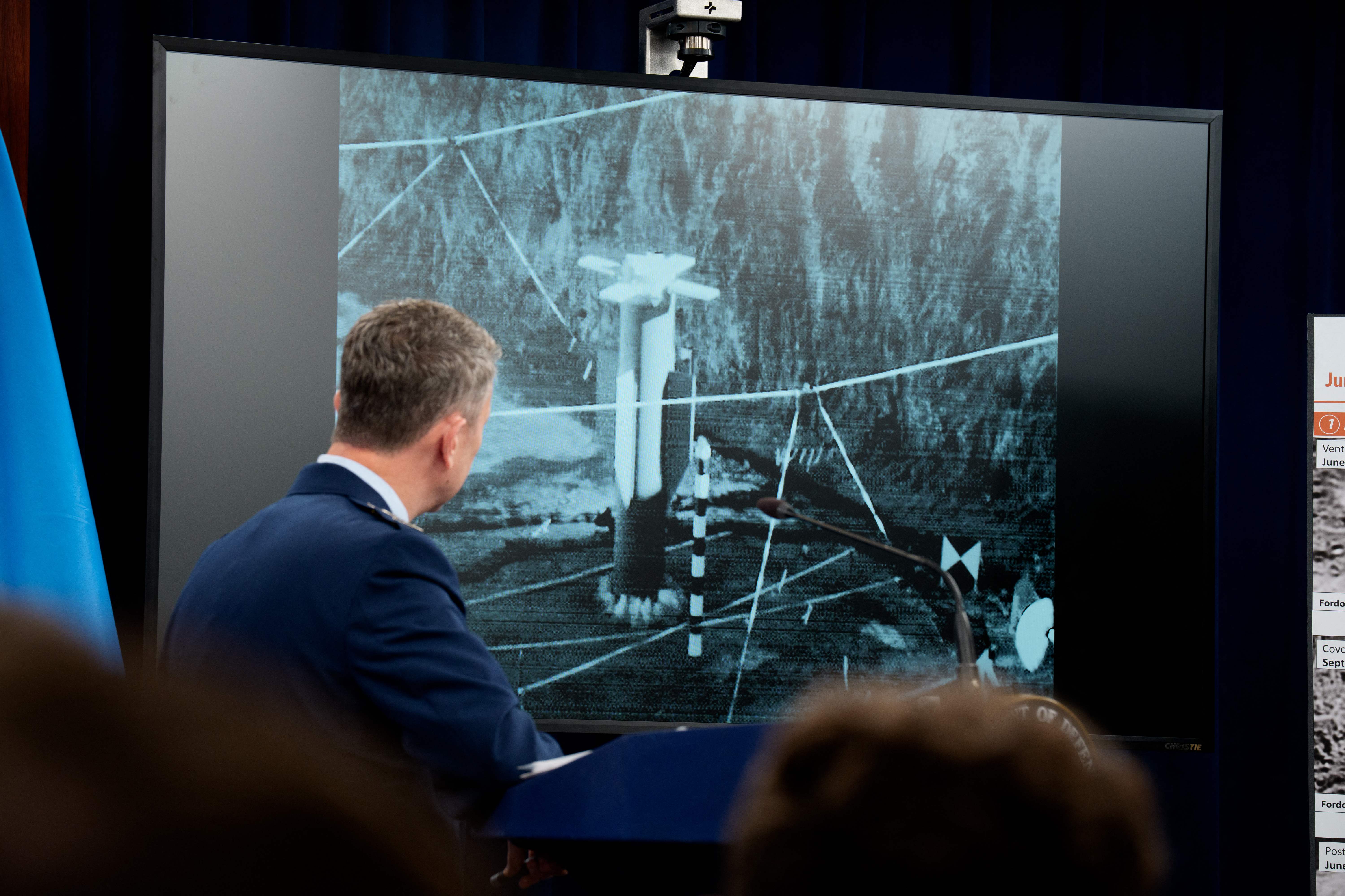 ARLINGTON, VIRGINIA - JUNE 26: Chairman of the Joint Chiefs of Staff Air Force Gen. Dan Caine turns to watch a video of a bombing test of the GBU-57A/B Massive Ordnance Penetrator (MOP) used in the attack on the Iranian Fordow Fuel Enrichment Plant during a news conference with U.S. Defense Secretary Pete Hegseth at the Pentagon on June 26, 2025 in Arlington, Virginia. The Department of Defense top officials gave an update after three Iranian nuclear facilities were struck by the U.S. military last weekend and Iran countered by launching missiles at Al Udeid Air Base in Doha, Qatar.   Andrew Harnik/Getty Images/AFP (Photo by Andrew Harnik / GETTY IMAGES NORTH AMERICA / Getty Images via AFP)