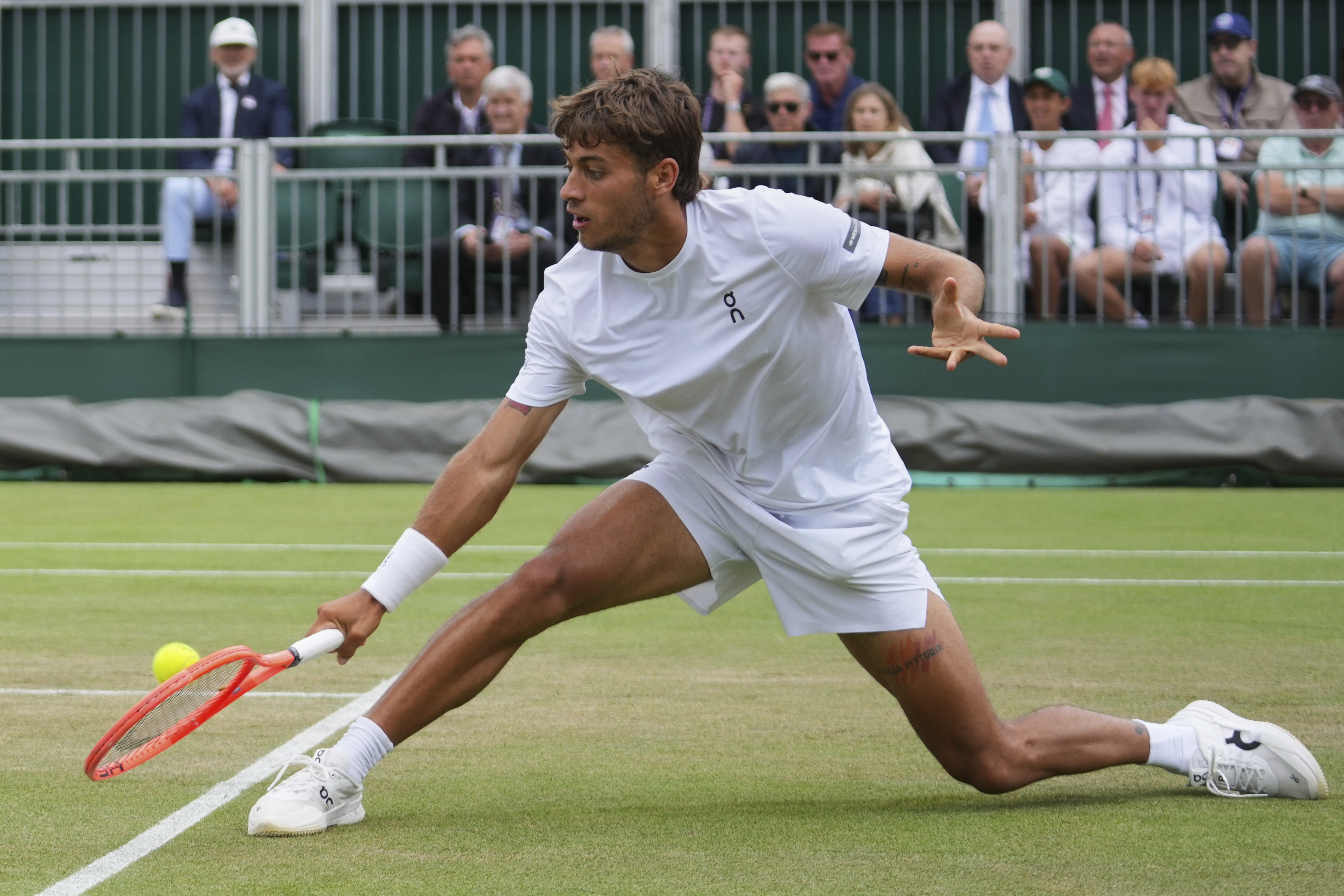 Flavio?Cobolli?of Italy returns to Jakub?Mensik?of Czech?Republic during a third round men's singles match at the Wimbledon Tennis Championships in London, Saturday, July 5, 2025. (AP Photo/Joanna Chan)
