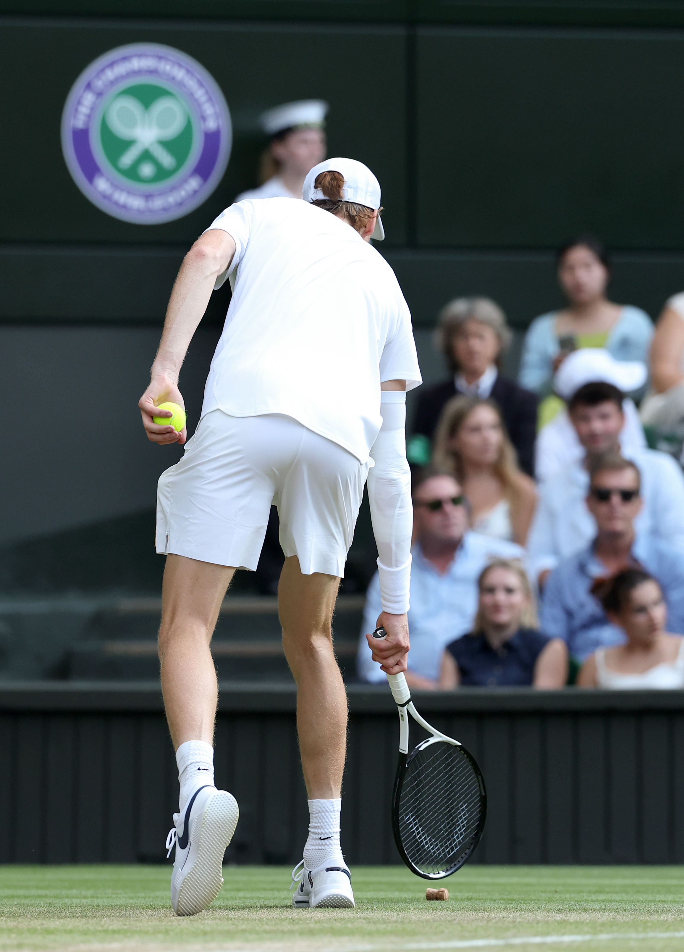 LONDON, ENGLAND - JULY 13: Jannik Sinner of Italy flicks a champagne cork on the court during the Gentleman's Singles Final against Carlos Alcaraz of Spain on day fourteen of The Championships Wimbledon 2025 at All England Lawn Tennis and Croquet Club on July 13, 2025 in London, England. (Photo by Julian Finney/Getty Images)